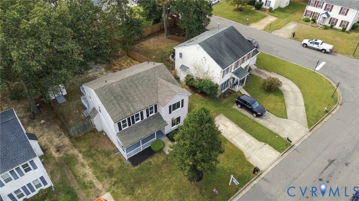 5831 Larrymore Road, Richmond, VA 23225 Two-story colonial exterior featuring a front porch, gabled roofline, concrete driveway, and a fenced rear yard