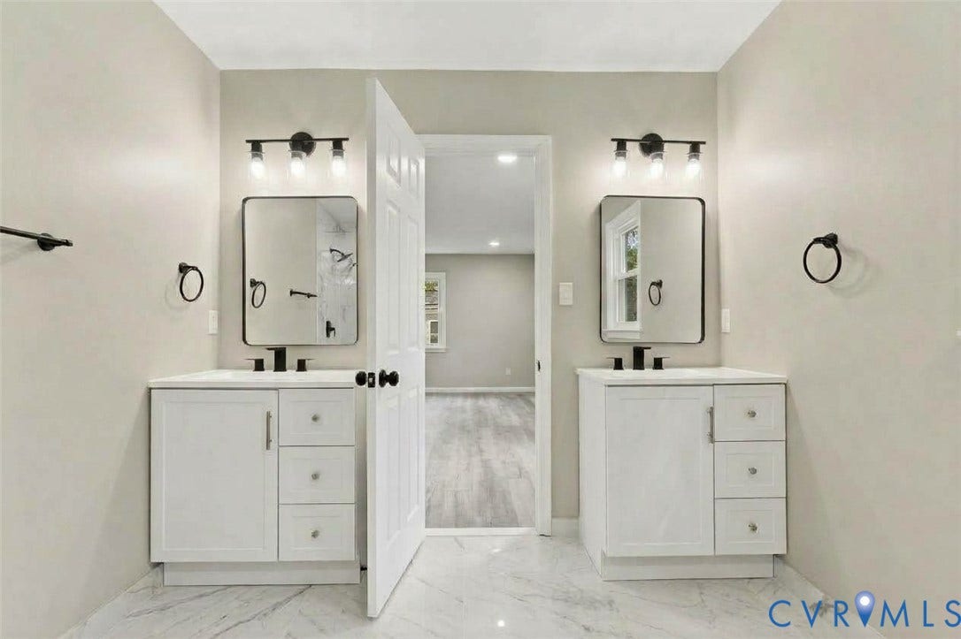 5831 Larrymore Road, Richmond, VA 23225 Dual white vanities featuring quartz countertops, rectangular undermount sinks, matte black fixtures, and framed mirrors with coordinating three-light wall sconces, finished with stone-look tile flooring