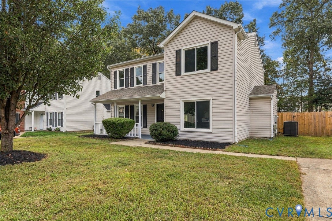 5831 Larrymore Road, Richmond, VA 23225 Two-story residence featuring light-toned horizontal siding, a covered front porch with white railing, and dark-finished decorative window shutters