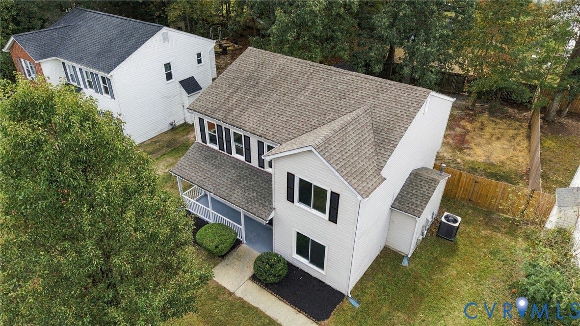 5831 Larrymore Road, Richmond, VA 23225 Two-story exterior with vinyl siding, shingle roof, covered front porch, and mature trees on a lot with perimeter fencing