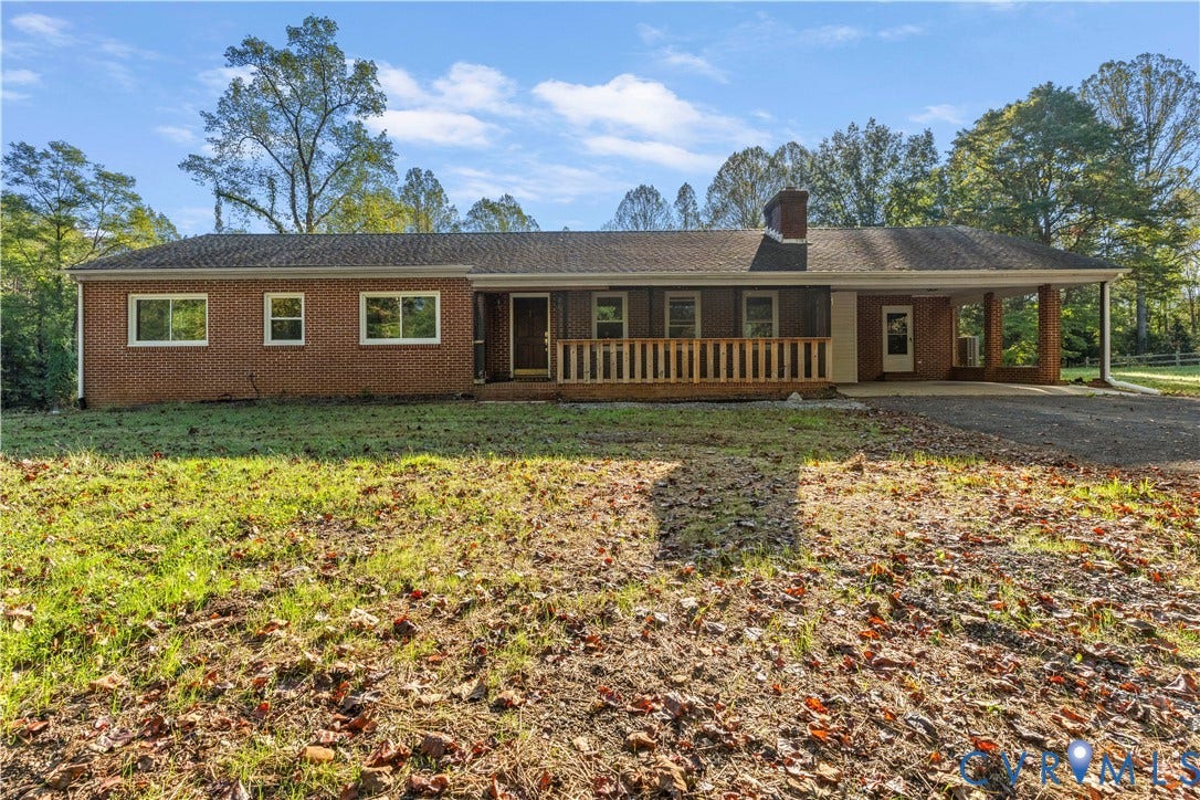 Brick exterior with a covered front porch featuring wood railing