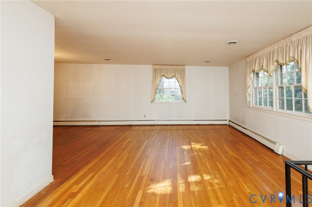 Spacious interior featuring wood-finish flooring, recessed lighting, and multi-pane windows