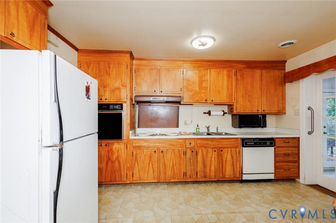 Kitchen featuring wood cabinetry, built-in wall oven, cooktop, dual-basin sink, and dishwasher