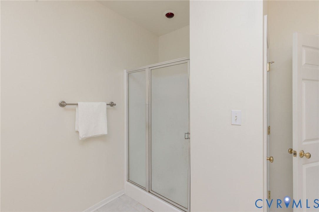 13742 Spyglass Hill Circle, Chesterfield, VA 23832 Walk-in shower featuring a framed glass enclosure, neutral wall finish, and a mounted metal towel bar