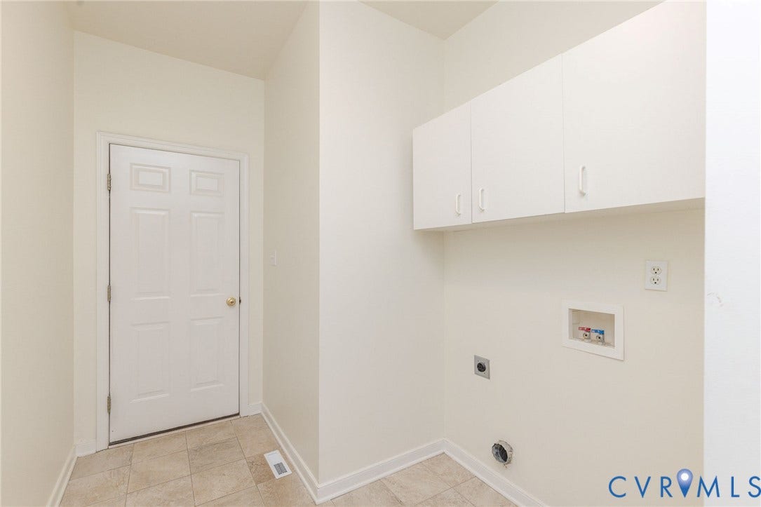 13742 Spyglass Hill Circle, Chesterfield, VA 23832 Utility area featuring tile flooring, white shaker-style wall-mounted cabinetry, and dedicated washer and dryer hookups