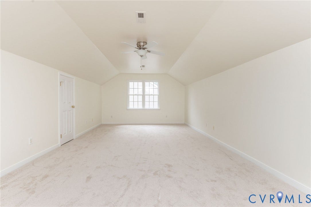 13742 Spyglass Hill Circle, Chesterfield, VA 23832 Interior space featuring vaulted ceilings, neutral wall tones, wall-to-wall carpeting, a multi-pane window, and a ceiling fan with integrated light fixture