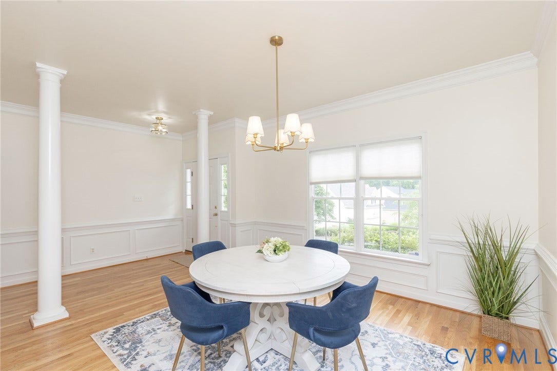 13742 Spyglass Hill Circle, Chesterfield, VA 23832 Wood-finish flooring, wainscoting, decorative architectural columns, crown molding, and a multi-arm metallic chandelier