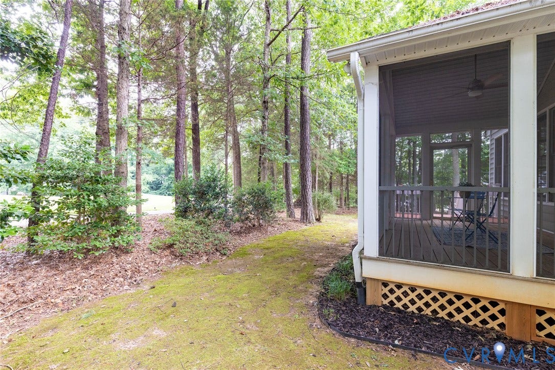 13742 Spyglass Hill Circle, Chesterfield, VA 23832 Screened-in porch featuring a ceiling fan and wooden lattice skirting, situated on a lot with mature trees and foliage