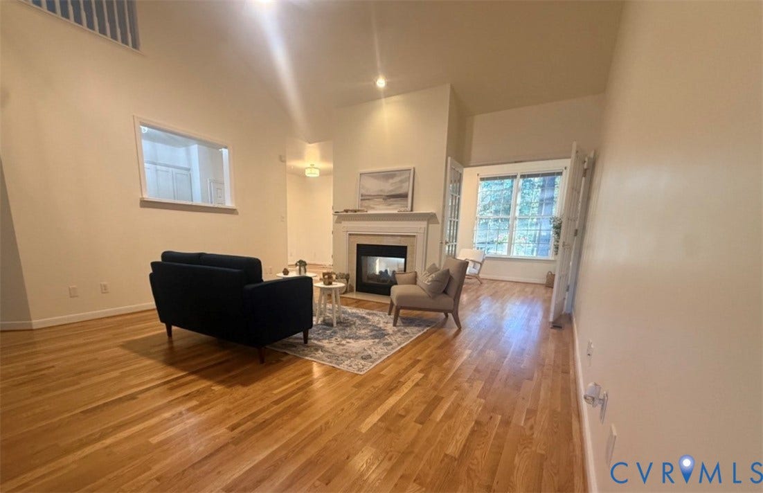 13742 Spyglass Hill Circle, Chesterfield, VA 23832 Vaulted ceilings, wood-finish flooring, central fireplace with a mantel, interior pass-through window, and multi-pane glass doors