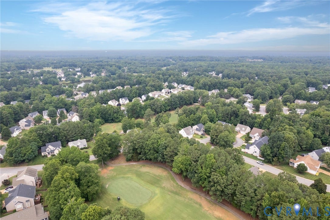 13742 Spyglass Hill Circle, Chesterfield, VA 23832 Aerial perspective featuring a manicured golf course green, expansive surrounding woodland, and residential infrastructure