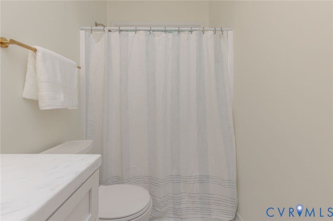13742 Spyglass Hill Circle, Chesterfield, VA 23832 Bathroom featuring a vanity with a white countertop, gold-toned hardware, and a combination tub and shower