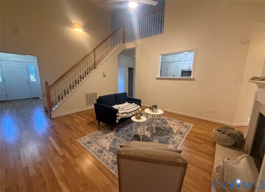 13742 Spyglass Hill Circle, Chesterfield, VA 23832 Vaulted ceilings, staircase with wooden handrail, wood-finish flooring, interior pass-through window, and fireplace surround