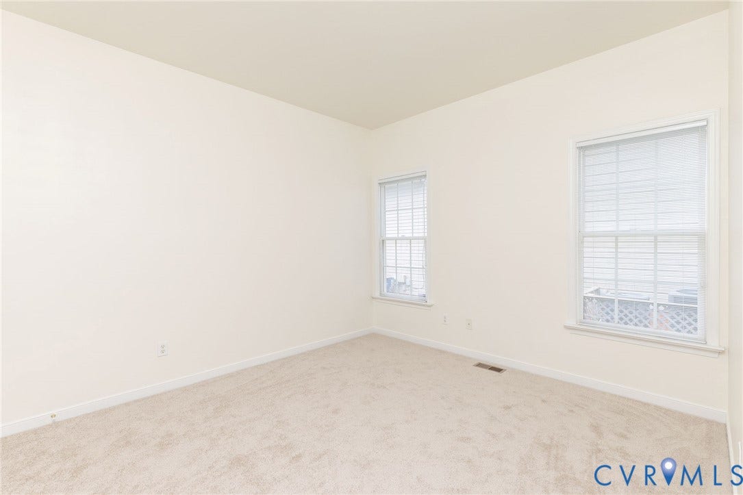 13742 Spyglass Hill Circle, Chesterfield, VA 23832 Neutral interior space featuring high ceilings, light-toned wall-to-wall carpeting, and two double-hung windows with integrated grid patterns