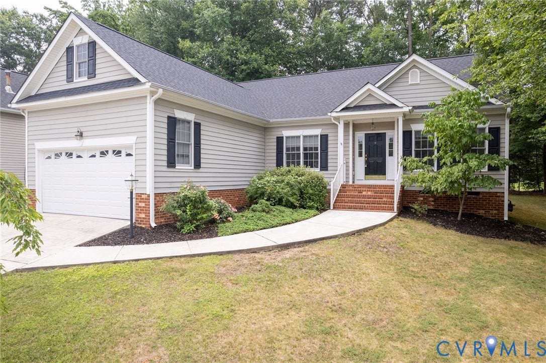 13742 Spyglass Hill Circle, Chesterfield, VA 23832 Traditional exterior featuring horizontal siding, a gabled roofline, brick foundation accents, a multi-pane front door, and a covered entryway