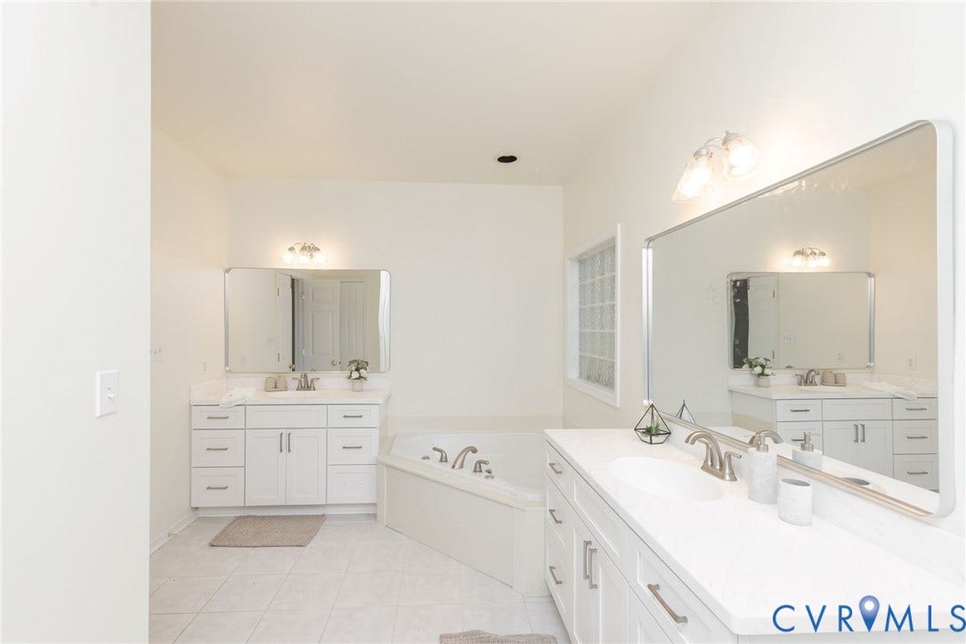 13742 Spyglass Hill Circle, Chesterfield, VA 23832 Dual white cabinetry vanities with light-toned countertops, inset sinks, chrome fixtures, large rectangular mirrors, and a corner soaking tub