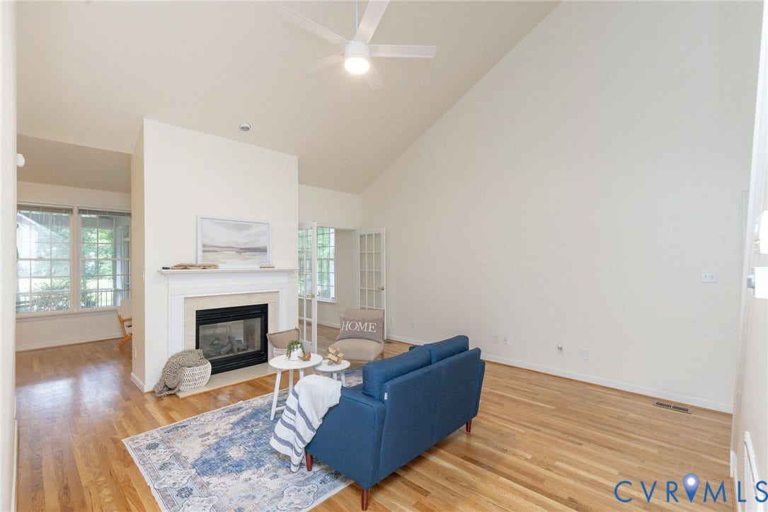 13742 Spyglass Hill Circle, Chesterfield, VA 23832 Vaulted ceilings, wood-finish flooring, central fireplace with a classic mantel, and multi-pane glass doors