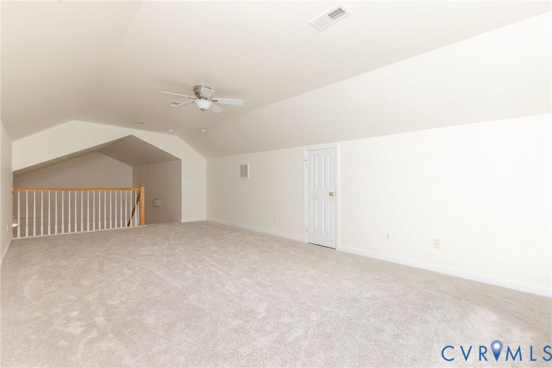 13742 Spyglass Hill Circle, Chesterfield, VA 23832 Vaulted ceiling featuring a central lighted ceiling fan, carpeted flooring, and a white wooden staircase railing