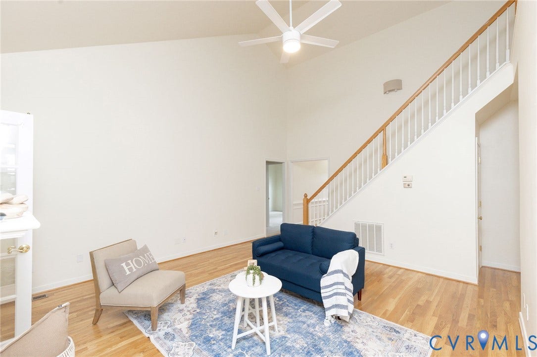 13742 Spyglass Hill Circle, Chesterfield, VA 23832 Vaulted ceilings, wood-finish flooring, staircase with a wood handrail and white balusters, and a ceiling fan with integrated lighting