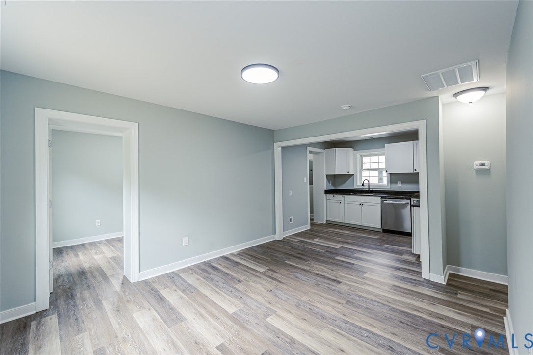 Wood-finish flooring throughout, with light-toned walls and crisp white trim