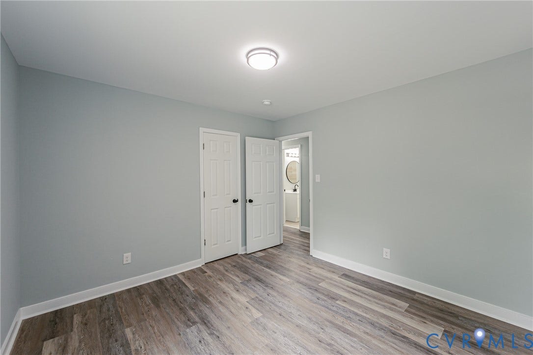Light gray walls with wood-finish flooring
