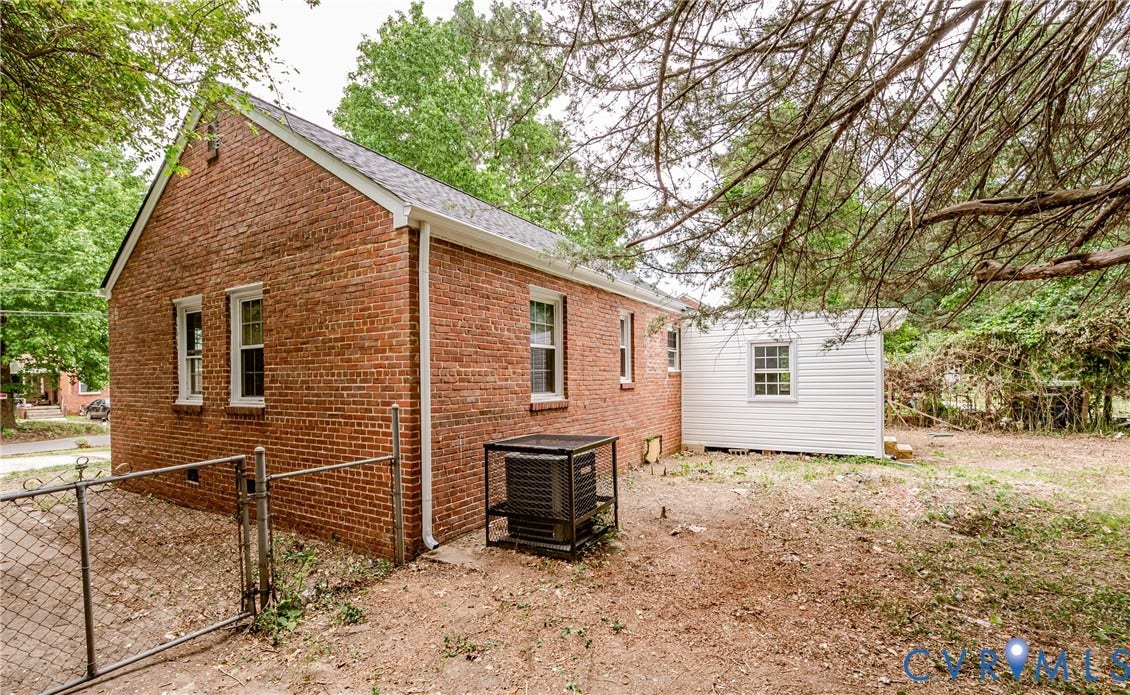 Brick exterior with white window trim and a gable roof