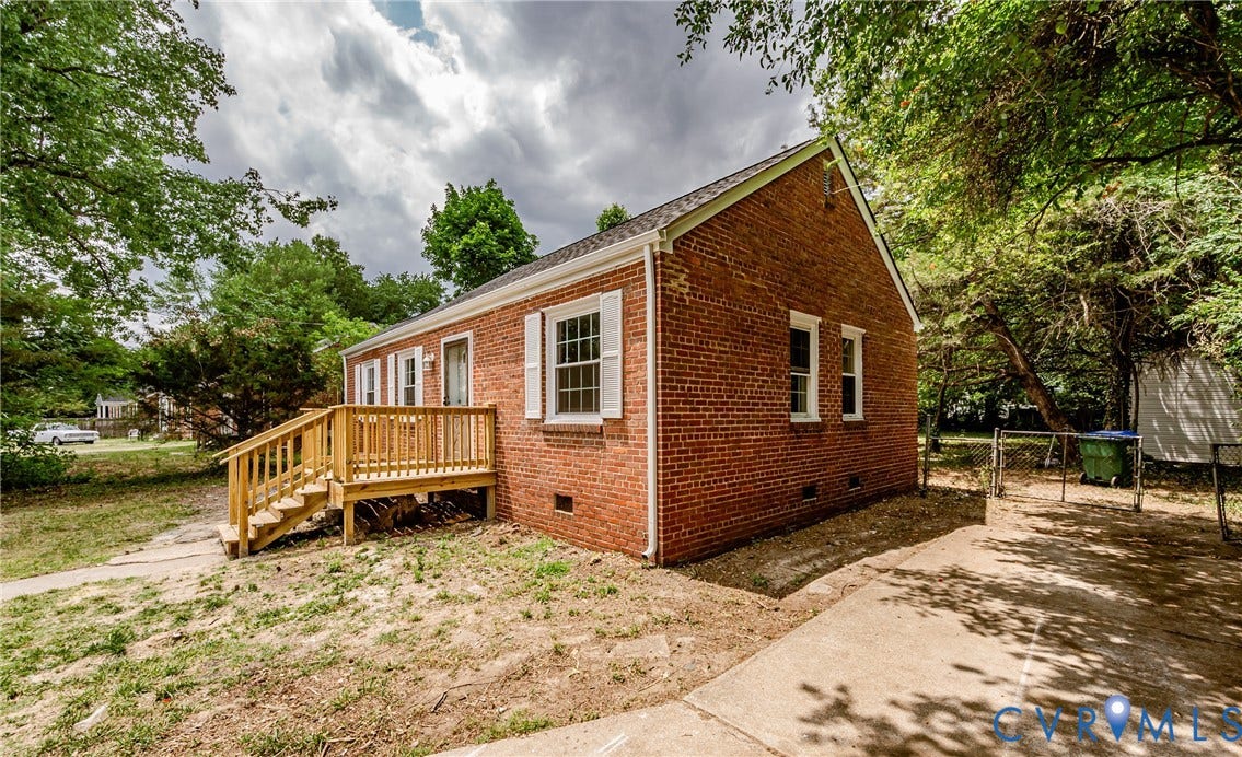 Brick exterior with a gabled roof and white window shutters