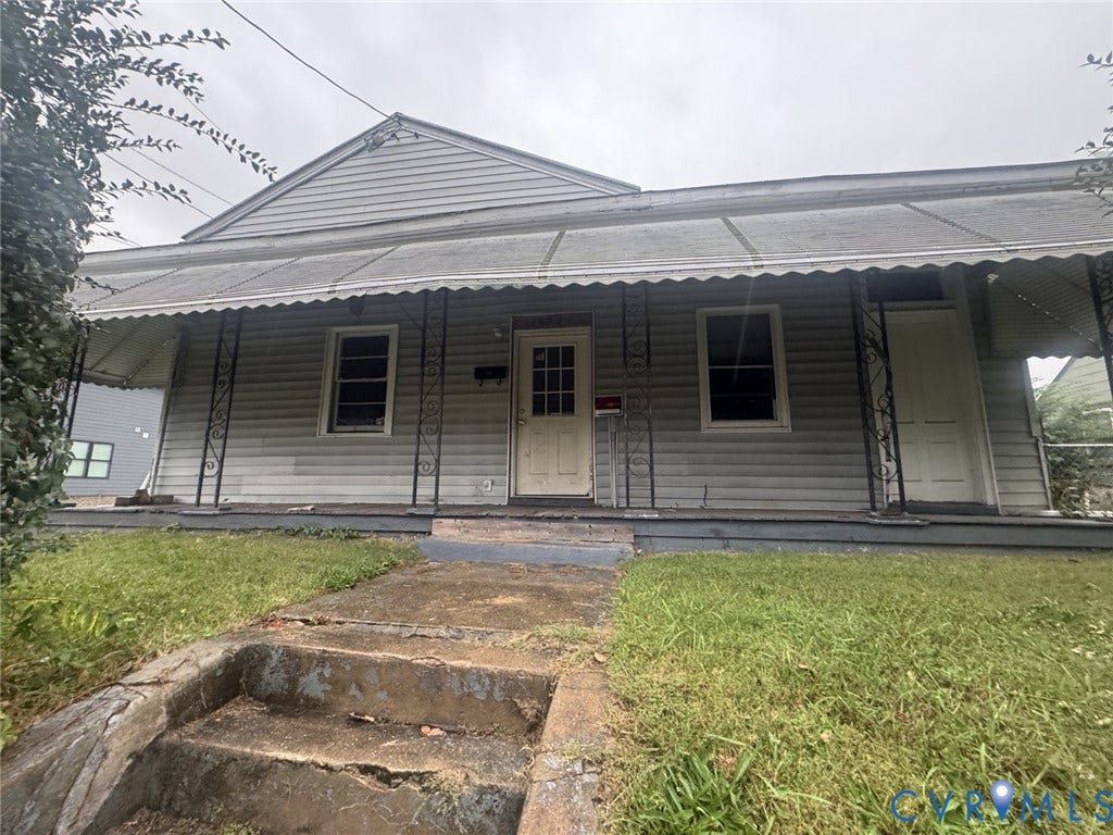 1400 N 29th Street, Richmond, VA 23223 Single-story exterior featuring light-colored horizontal siding, a covered porch with decorative metal supports, and dual-entry doors
