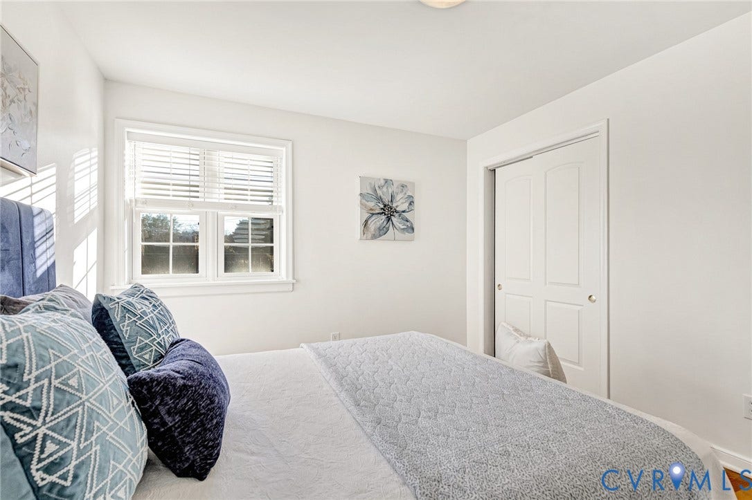 4520 Grove Avenue, #U5, Westhampton, Richmond, VA 23221 White walls with a window featuring blinds, a ceiling-mounted light fixture, and a bi-fold closet door