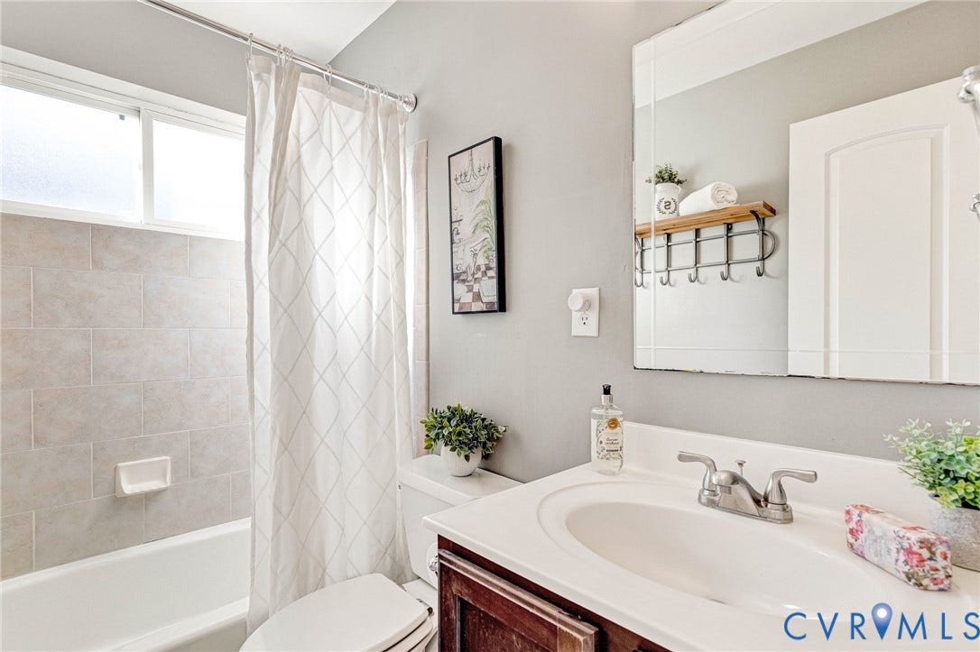 4520 Grove Avenue, #U5, Westhampton, Richmond, VA 23221 Tub and shower combination with light-colored rectangular tile surround