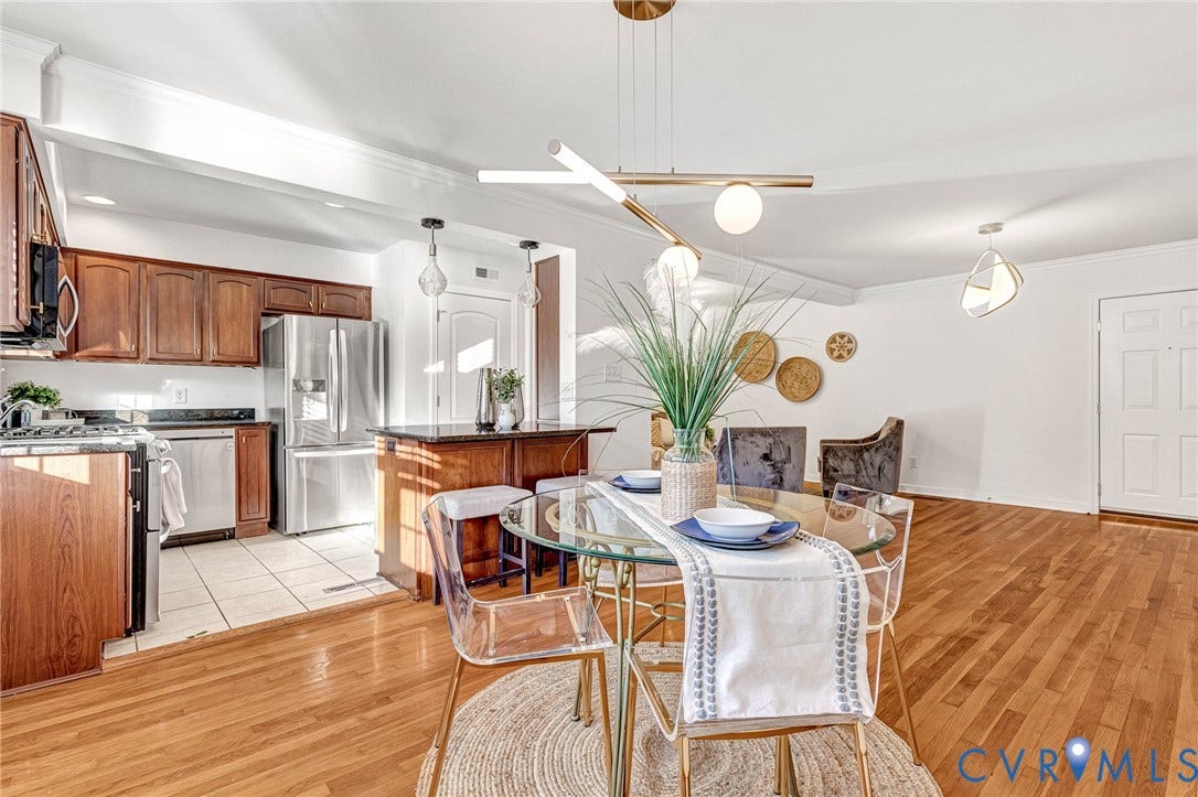 4520 Grove Avenue, #U5, Westhampton, Richmond, VA 23221 Hardwood flooring throughout, kitchen with wood cabinetry, stainless steel appliances, and tile flooring, and a breakfast bar with stone-finish countertop
