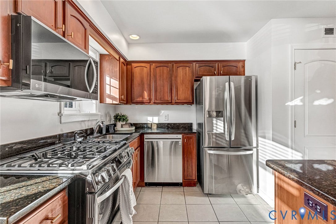 4520 Grove Avenue, #U5, Westhampton, Richmond, VA 23221 Kitchen featuring wood cabinetry, dark countertops, stainless steel appliances, and tile flooring