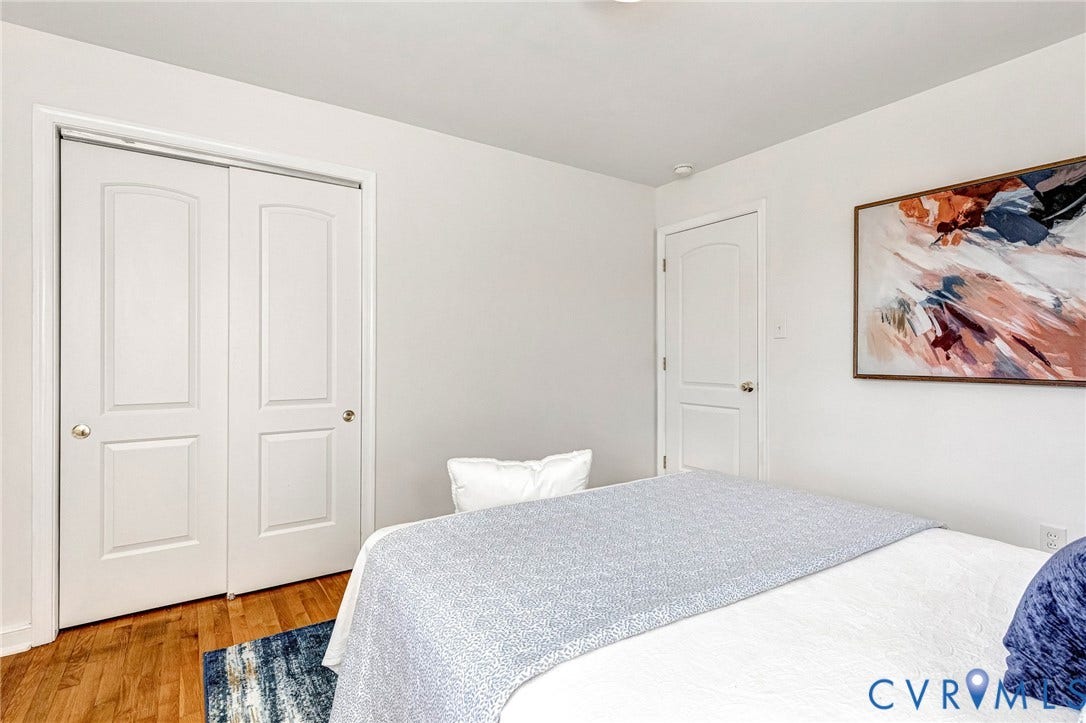 4520 Grove Avenue, #U5, Westhampton, Richmond, VA 23221 Recessed lighting, wood-finish flooring, white paneled bifold doors, and a white paneled door with a brass-finish knob