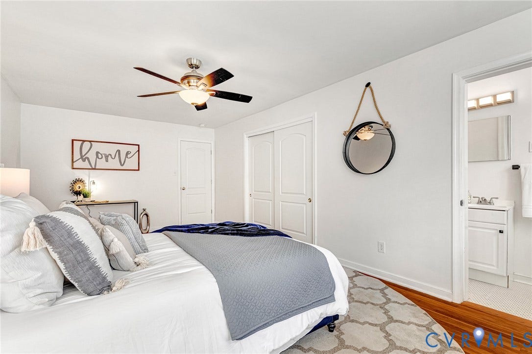 4520 Grove Avenue, #U5, Westhampton, Richmond, VA 23221 Ceiling fan with integrated lighting, wood-finish flooring, white double bi-fold closet doors, white vanity with integrated sink, and wall-mounted vanity lighting