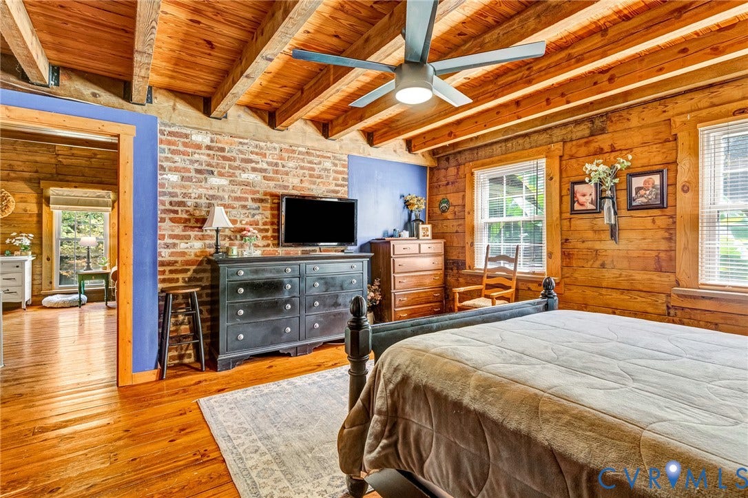 8328 Peaks Road, Hanover, VA 23069 Exposed wood beam ceiling, wood-finish flooring, exposed brick wall, wood-paneled walls, and multiple windows