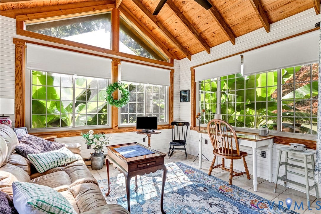 8328 Peaks Road, Hanover, VA 23069 Vaulted wood-plank ceiling with exposed beams, large picture windows, wood-finish window frames, white paneled walls, and tile flooring