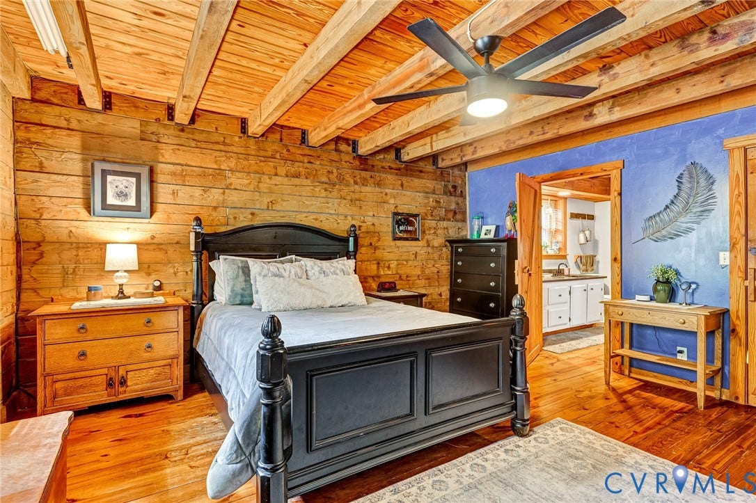8328 Peaks Road, Hanover, VA 23069 Wood-plank walls and ceiling featuring exposed beams, wood-finish flooring, and a ceiling fan