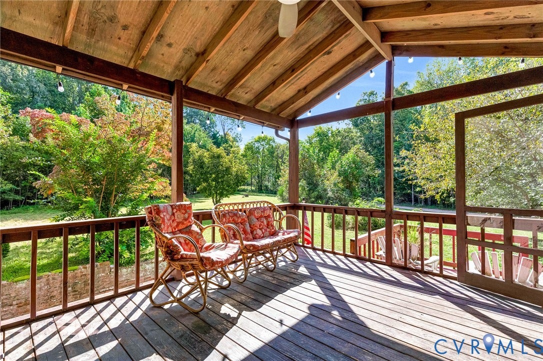 8328 Peaks Road, Hanover, VA 23069 Expansive screened porch with a wood-plank floor, exposed wood beam ceiling, and verdant surroundings