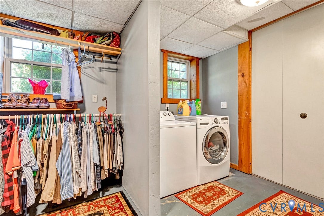 8328 Peaks Road, Hanover, VA 23069 Windowed utility space featuring a washer and dryer, adjacent to a storage area with built-in shelving and hanging rods