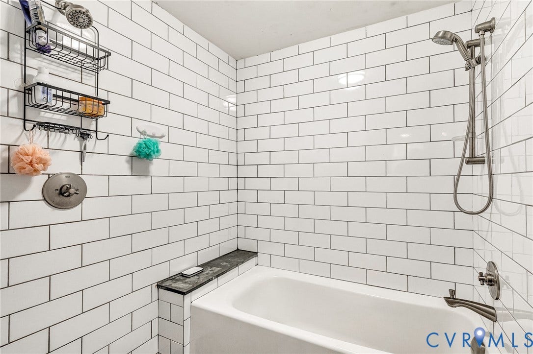 8328 Peaks Road, Hanover, VA 23069 Bathtub with subway tile surround, built-in ledge, and brushed nickel fixtures including a handheld showerhead