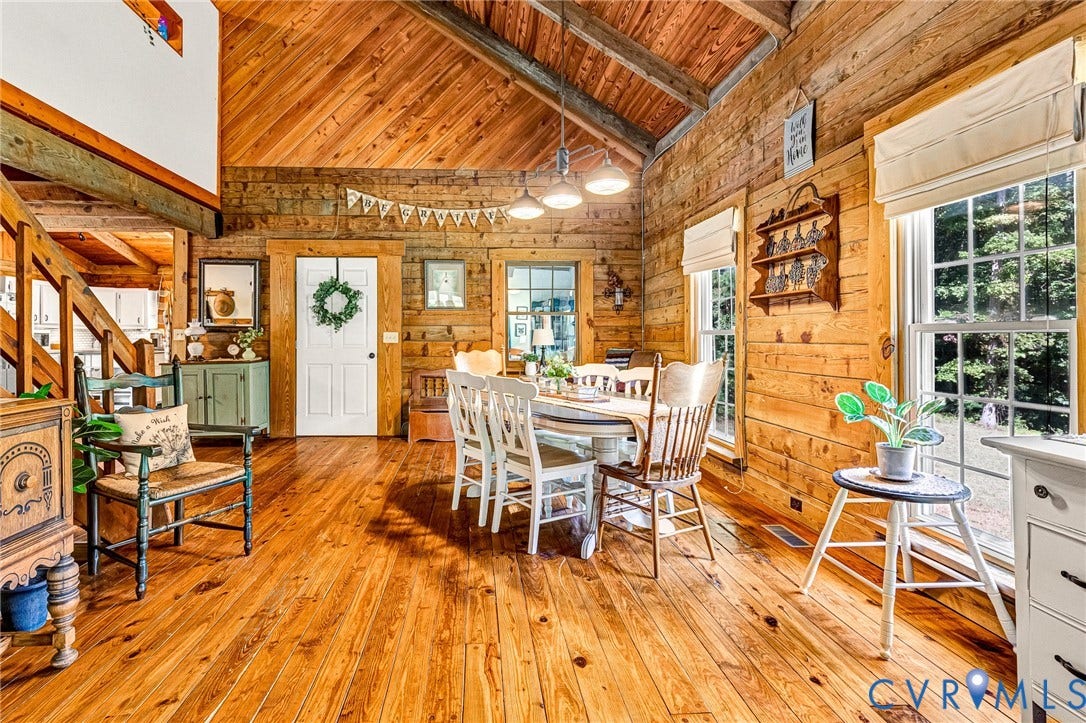 8328 Peaks Road, Hanover, VA 23069 Vaulted wood-paneled ceiling, wood-plank walls, wood-finish flooring, staircase with wood banister, and multiple windows