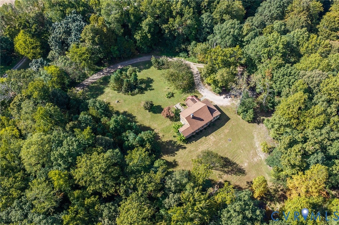 8328 Peaks Road, Hanover, VA 23069 Expansive wooded property featuring a residential structure with a brown shingle roof, a gravel driveway, and surrounding green lawn areas