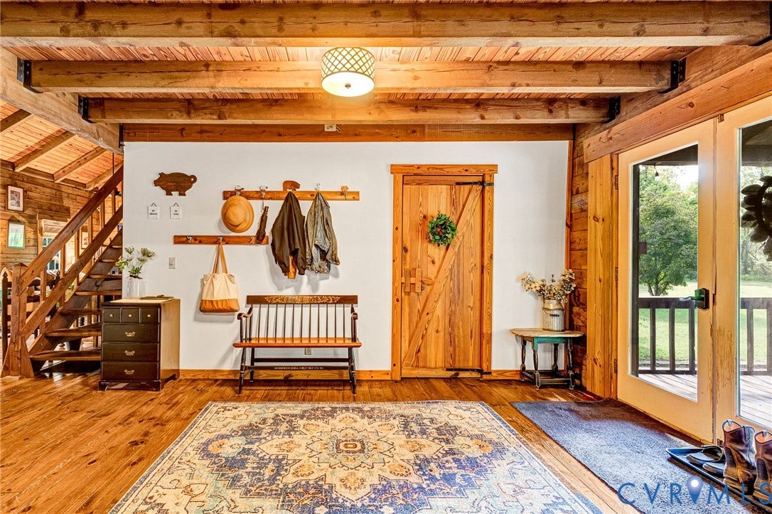 8328 Peaks Road, Hanover, VA 23069 Exposed wood beams, wood-finish flooring, wood staircase, white walls, and a wood barn door