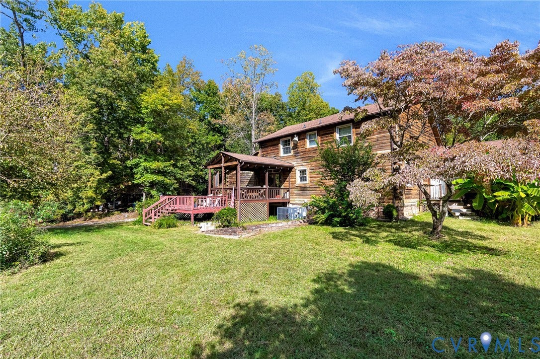 8328 Peaks Road, Hanover, VA 23069 Wood-sided exterior with multiple windows, covered deck, and a mature tree with colorful foliage