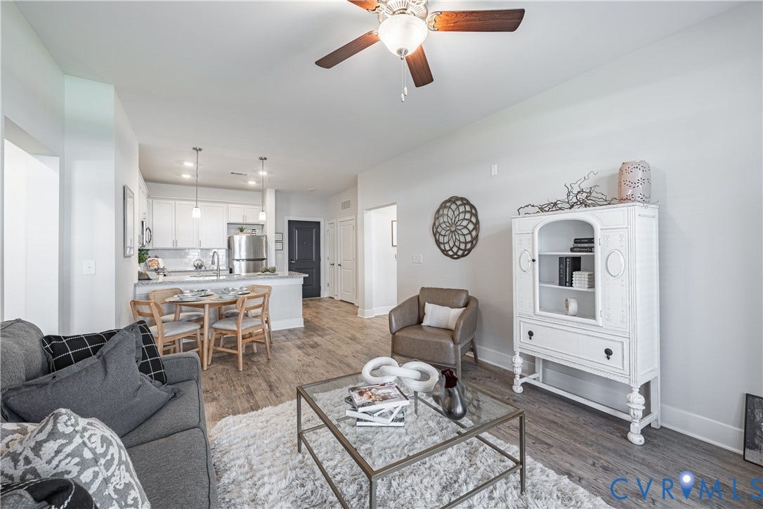 Open-concept living space featuring wood-finish flooring, a ceiling fan, and recessed lighting