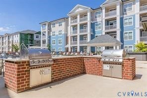 Outdoor grilling station featuring brickwork, two built-in stainless steel grills, and integrated cabinetry