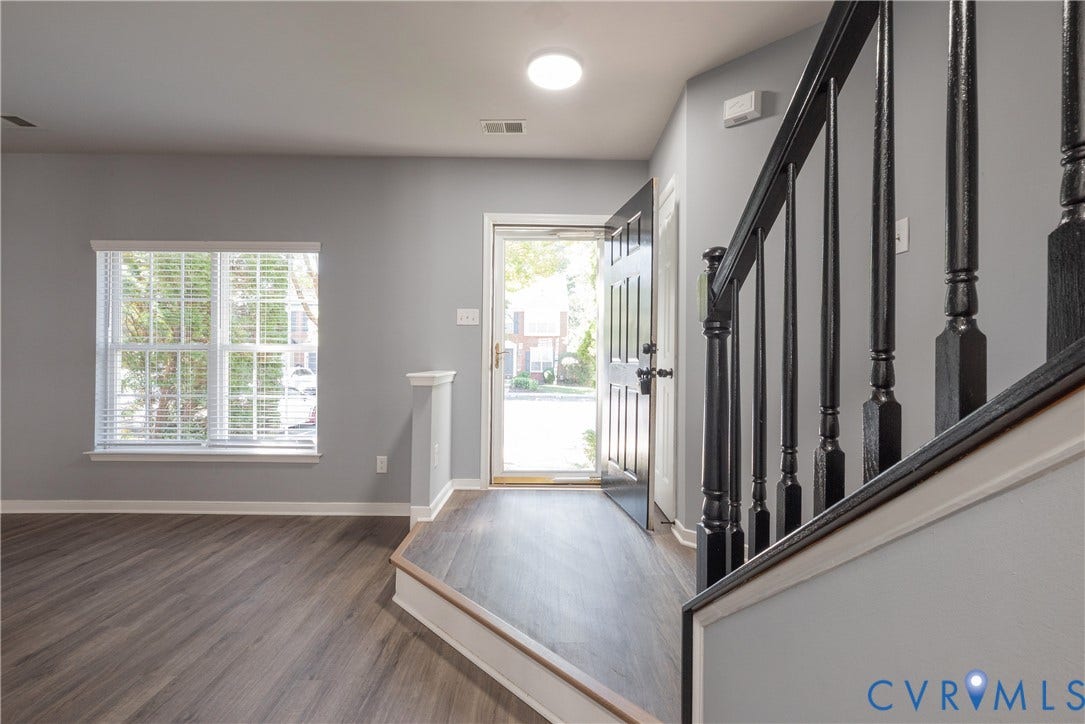 New flooring, white window blinds, with step down to the Living Room