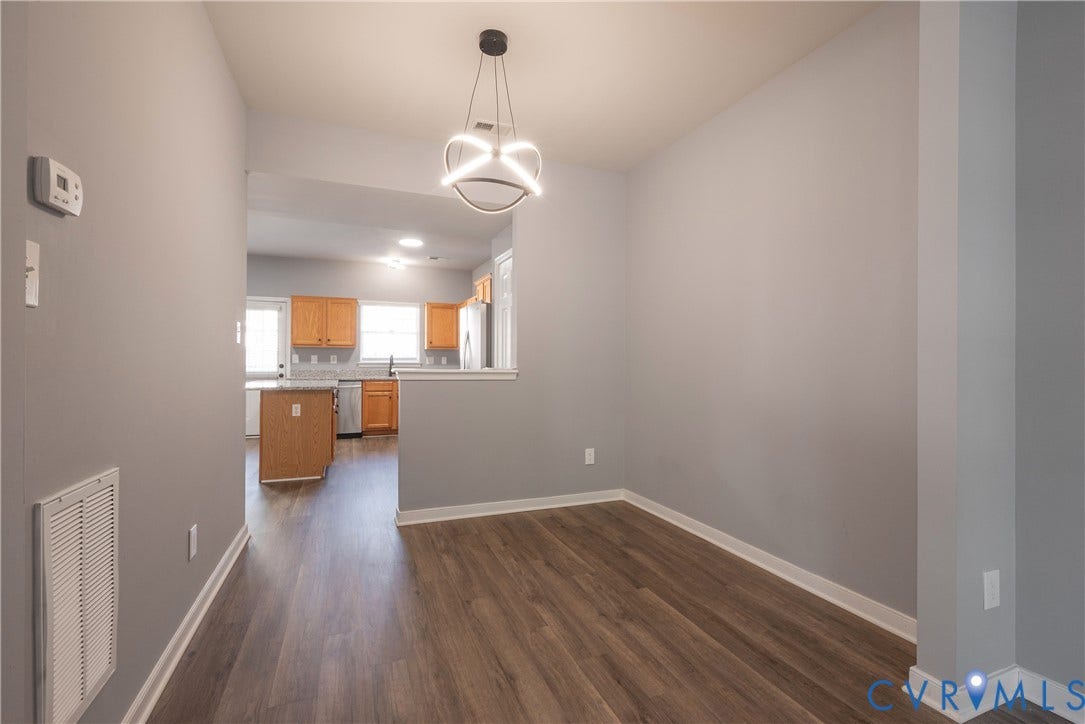 New flooring throughout, contemporary pendant lighting, light gray wall tones, and white trim