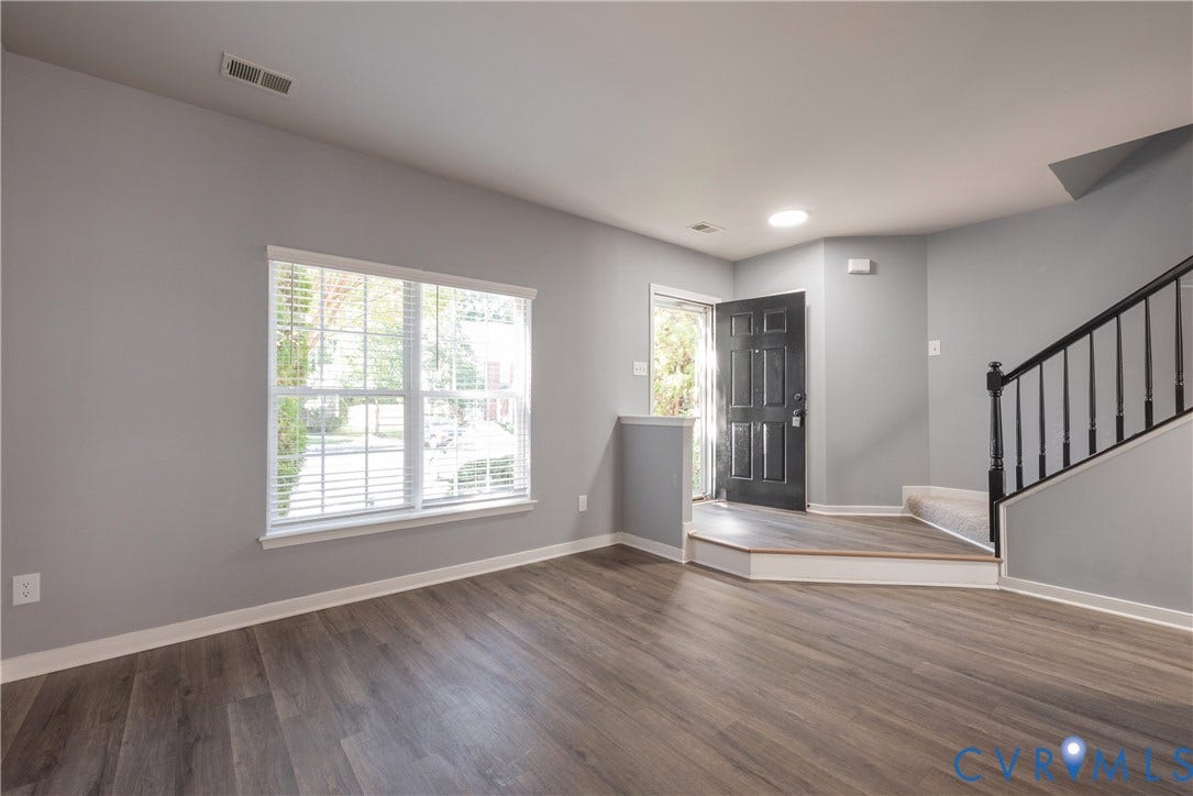 Great area for entertaining family and friends soft gray wall paint, and a white window frame with blinds