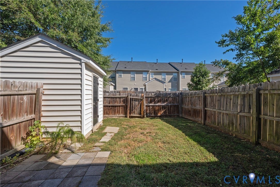 Private backyard featuring a wood privacy fence and a storage shed