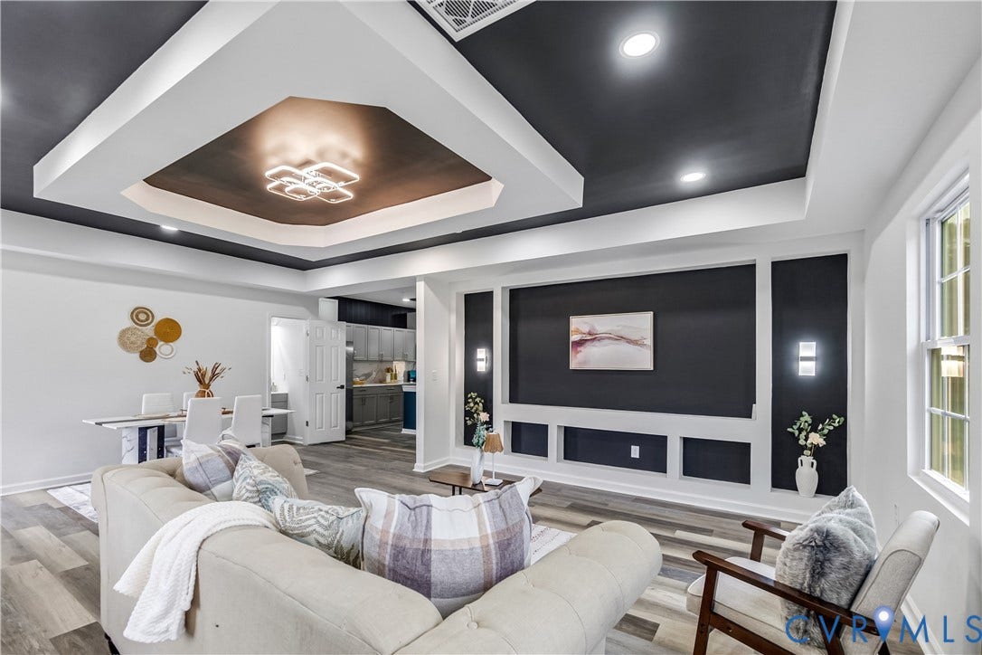 Tray ceiling with recessed lighting and a decorative fixture